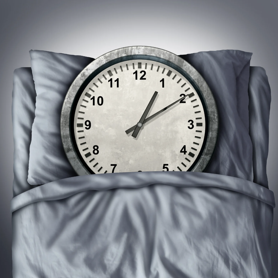 a clock sleeping in a bed